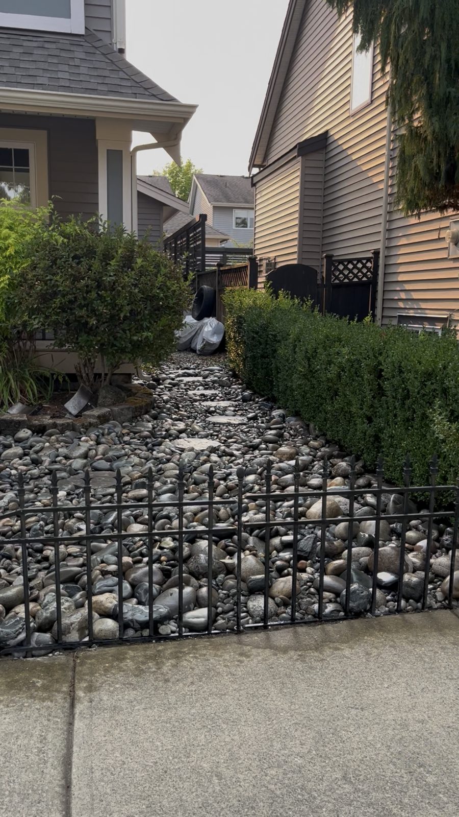 Front yard finished with river rock and a stone path